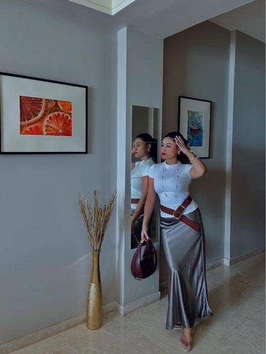 Sreeparna Poddar, the artist behind Canvas Woman, at home with framed paintings behind her